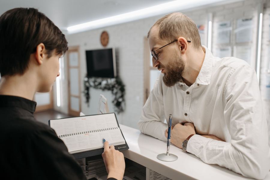 Patient checking in at a bright clinic reception desk