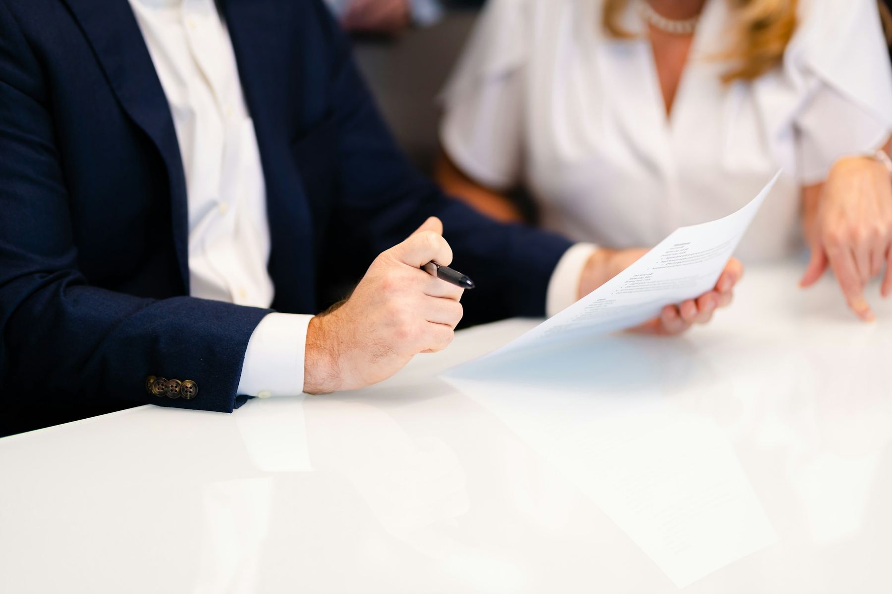 Tax document being passed across a table for signature